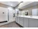 This bathroom offers a double vanity with plentiful counter space and a walk-in shower with glass door at 13657 W Paso Trl, Peoria, AZ 85383