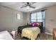 Bedroom features ceiling fan, natural light, and carpeted flooring at 13657 W Paso Trl, Peoria, AZ 85383
