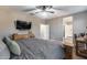 This bedroom features a large bed, carpet and an ensuite bathroom with walk-in closet at 13657 W Paso Trl, Peoria, AZ 85383