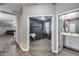 Hallway view showcasing lash room, tile flooring, and connecting living spaces at 13657 W Paso Trl, Peoria, AZ 85383