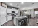 Open concept kitchen with island seating flows into the dining area, perfect for entertaining guests at 13657 W Paso Trl, Peoria, AZ 85383