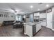 Open floor plan with kitchen island, connecting living room, and stainless steel appliances at 13657 W Paso Trl, Peoria, AZ 85383