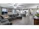 This open-concept living room features modern finishes and ample natural light, flowing seamlessly into the kitchen at 13657 W Paso Trl, Peoria, AZ 85383