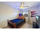 Cozy bedroom featuring a wood frame bed, ceiling fan, and fun decor at 1414 E Cathedral Rock Dr, Phoenix, AZ 85048