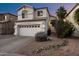 Two-story home features a front yard with desert landscaping and a two car garage at 1414 E Cathedral Rock Dr, Phoenix, AZ 85048