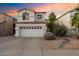 Charming two-story home featuring a spacious driveway, a two-car garage, and desert landscaping at 1414 E Cathedral Rock Dr, Phoenix, AZ 85048