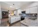 Well-lit kitchen featuring sleek white cabinets, granite countertops, stainless steel appliances, and tile backsplash at 1414 E Cathedral Rock Dr, Phoenix, AZ 85048