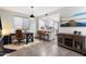 Open living space featuring a desk, entertainment center, and kitchen island with bar seating at 1414 E Cathedral Rock Dr, Phoenix, AZ 85048