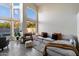 Sun-filled living room with high ceilings, large windows, and a gray sectional sofa with decorative pillows at 1414 E Cathedral Rock Dr, Phoenix, AZ 85048