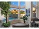 Bright sitting area with large windows overlooking a pool and mountain views, and greenery throughout at 1414 E Cathedral Rock Dr, Phoenix, AZ 85048