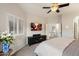 Serene bedroom with shuttered windows, TV, ceiling fan, and soft neutral tones at 1414 E Cathedral Rock Dr, Phoenix, AZ 85048