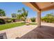 Inviting back patio with artificial grass, stone pavers, and a covered area, perfect for outdoor relaxation at 14771 W Columbus Ave, Goodyear, AZ 85395