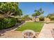 Secluded backyard with artificial grass, mature landscaping, and a serene atmosphere at 14771 W Columbus Ave, Goodyear, AZ 85395