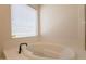 Bright bathroom features a soaking tub and natural light, perfect for a relaxing retreat at 14771 W Columbus Ave, Goodyear, AZ 85395