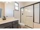 Bathroom featuring a shower, and a sink with dark cabinetry at 14771 W Columbus Ave, Goodyear, AZ 85395
