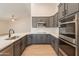 A beautifully updated kitchen showcases gray cabinets, quartz countertops, and new stainless appliances at 14771 W Columbus Ave, Goodyear, AZ 85395
