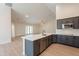 New open kitchen featuring gray cabinets, island with quartz countertops, and stainless appliances at 14771 W Columbus Ave, Goodyear, AZ 85395