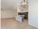 Open-concept living space featuring a modern kitchen with gray cabinets, island and a spacious layout at 14771 W Columbus Ave, Goodyear, AZ 85395