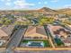 Aerial view of a home with a private pool, fire pit, and a manicured backyard in a gated community at 16417 W Fawn Dr, Goodyear, AZ 85338