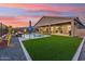 Expansive backyard with a pool, lush turf, and a covered patio for seamless indoor-outdoor living at 16417 W Fawn Dr, Goodyear, AZ 85338