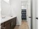Bathroom featuring a vanity with dark wood cabinetry and a separate shower area at 16417 W Fawn Dr, Goodyear, AZ 85338
