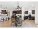 Open dining area with modern chandelier, breakfast bar, dark cabinets, and stainless steel appliances at 16417 W Fawn Dr, Goodyear, AZ 85338