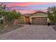 Inviting home with a paver driveway, desert landscaping, and a well-manicured front yard at 16417 W Fawn Dr, Goodyear, AZ 85338