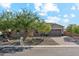 Attractive single-story home featuring stone accents, a well-manicured yard, and desert landscaping at 16417 W Fawn Dr, Goodyear, AZ 85338