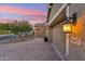 Charming home exterior with a three-car garage, paver driveway, and well-maintained landscaping at 16417 W Fawn Dr, Goodyear, AZ 85338