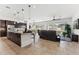 Open-concept kitchen and living area with a large island, modern lighting, and mountain views at 16417 W Fawn Dr, Goodyear, AZ 85338