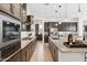 Well-equipped kitchen with granite countertops, center island, stainless steel appliances, and modern cabinetry at 16417 W Fawn Dr, Goodyear, AZ 85338