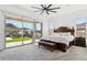 Main bedroom with beautiful backyard view, patio access, a ceiling fan, and carpet flooring at 16417 W Fawn Dr, Goodyear, AZ 85338