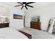 Main bedroom with carpet floors, a ceiling fan, furniture, and an ensuite bathroom at 16417 W Fawn Dr, Goodyear, AZ 85338