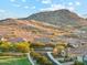 Scenic view of a residential neighborhood nestled against the backdrop of a mountain at 16417 W Fawn Dr, Goodyear, AZ 85338