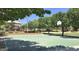 Recreational basketball court with playground equipment and surrounding trees at 17344 W Adams St, Goodyear, AZ 85338
