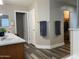Bathroom with double doors, a large mirror, and a walk-in closet with ample storage space at 17344 W Adams St, Goodyear, AZ 85338