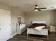 Cozy bedroom featuring a ceiling fan, a white bed frame, and light, neutral-colored walls at 17344 W Adams St, Goodyear, AZ 85338