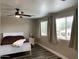 Bright bedroom with two large windows, a ceiling fan, neutral walls, and luxury vinyl plank flooring at 17344 W Adams St, Goodyear, AZ 85338