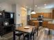 Well-lit kitchen with a wooden table, ample storage, stainless steel appliances, and luxury vinyl plank flooring at 17344 W Adams St, Goodyear, AZ 85338