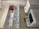Organized laundry room features white appliances and shelving units, providing ample storage and convenience for laundry tasks at 17344 W Adams St, Goodyear, AZ 85338