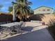 A decorative concrete patio offers an outdoor dining area with a table and an umbrella at 17344 W Adams St, Goodyear, AZ 85338