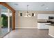 Bright dining area with sliding glass doors and updated lighting at 1768 E Grand Ridge Rd, Queen Creek, AZ 85140