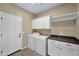 Laundry room with white appliances and cabinet storage at 1768 E Grand Ridge Rd, Queen Creek, AZ 85140