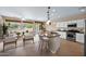 Bright, open-concept living room and kitchen with modern appliances and a breakfast bar at 1768 E Grand Ridge Rd, Queen Creek, AZ 85140