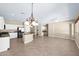 Spacious living area features tile floors, neutral walls, and a kitchen with white cabinetry at 1768 E Grand Ridge Rd, Queen Creek, AZ 85140