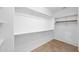 A walk-in closet with white shelving and tile floor at 1768 E Grand Ridge Rd, Queen Creek, AZ 85140