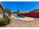 Inviting backyard with patio and pool, covered patio with stone supports, and brick paver deck at 18041 W Ivy Ln, Surprise, AZ 85388