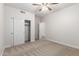 Bedroom featuring a closet with sliding doors, a ceiling fan, and neutral carpeting for a comfortable feel at 18041 W Ivy Ln, Surprise, AZ 85388