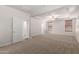 Spacious bedroom with a ceiling fan and tray ceiling with two door openings at 18041 W Ivy Ln, Surprise, AZ 85388