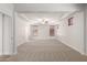 Large main bedroom with a tray ceiling, carpet, and multiple windows with wood blinds at 18041 W Ivy Ln, Surprise, AZ 85388